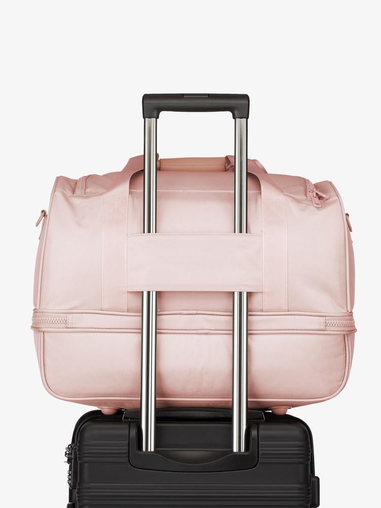 pink sand CALPAK Stevyn duffel bag with luggage trolley sleeve
